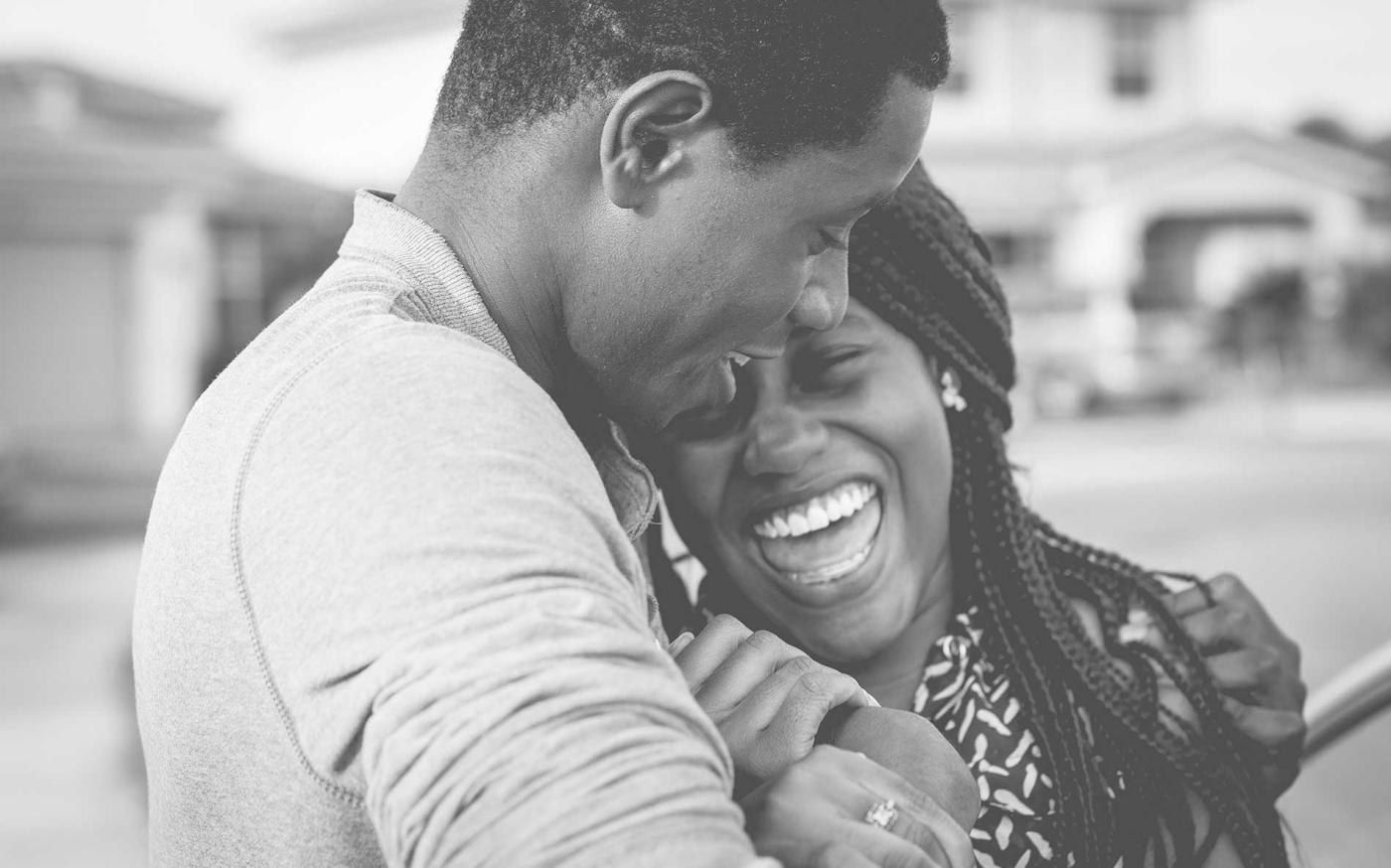 A black and white image of a couple laughing