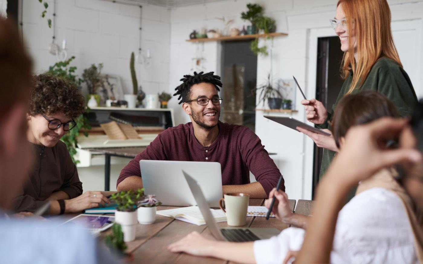 Group of young professionals in a meeting. They are in a casual office setting